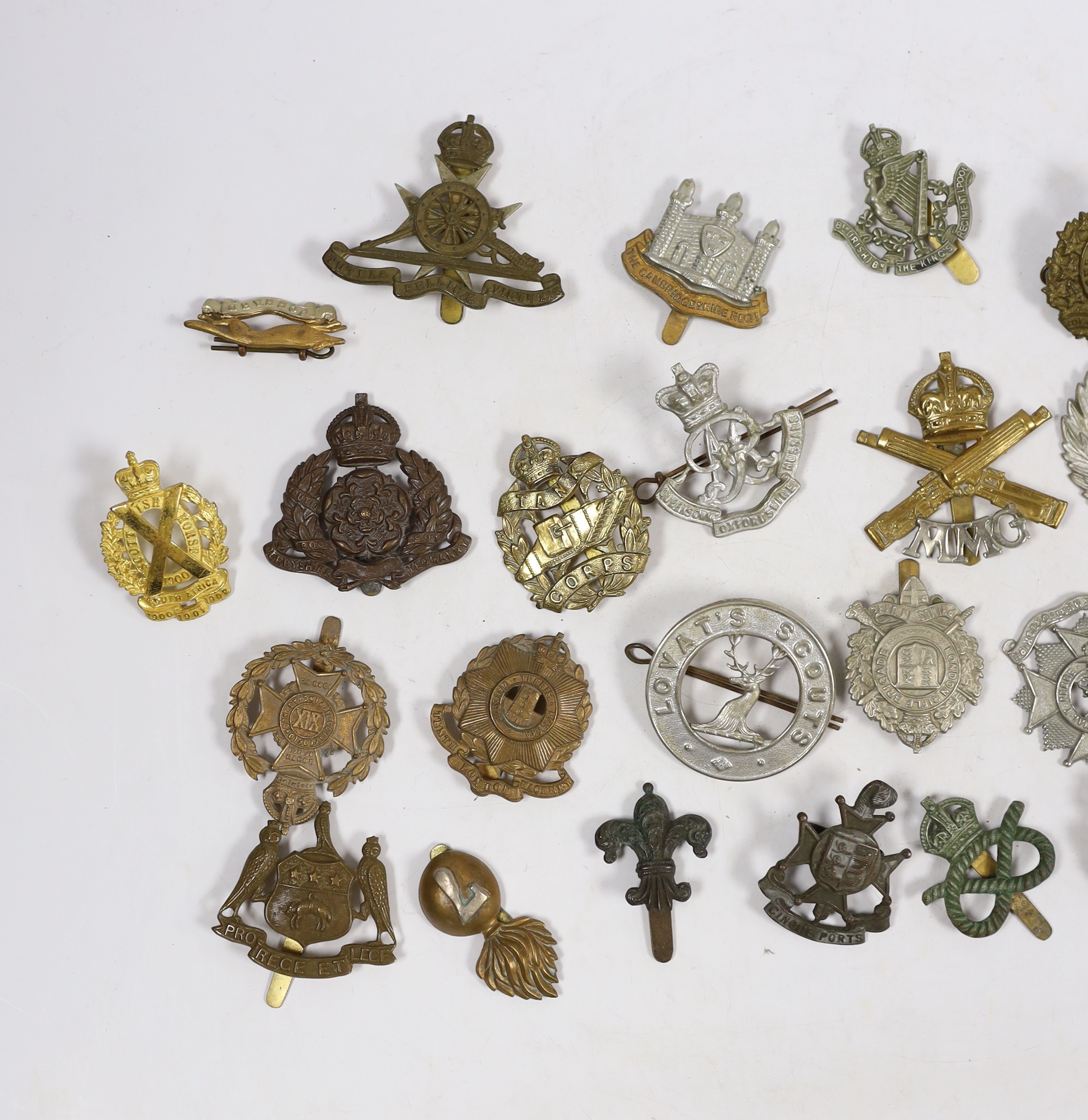 Thirty military cap badges including Royal Canadian Engineers, Royal Gloucestershire Hussars, the Robin Hoods, RAF, the Cambridgeshire Regiment, Tank Corps, Huntingdonshire, Westminster Dragoons, Cinque Ports, Derbyshire